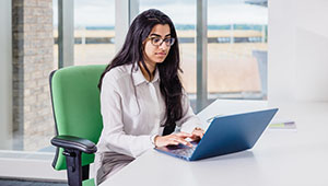 Female_student_using_blue_laptop