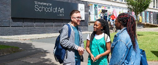 Three students at Walsall Campus standing outside the School of Creative Industries