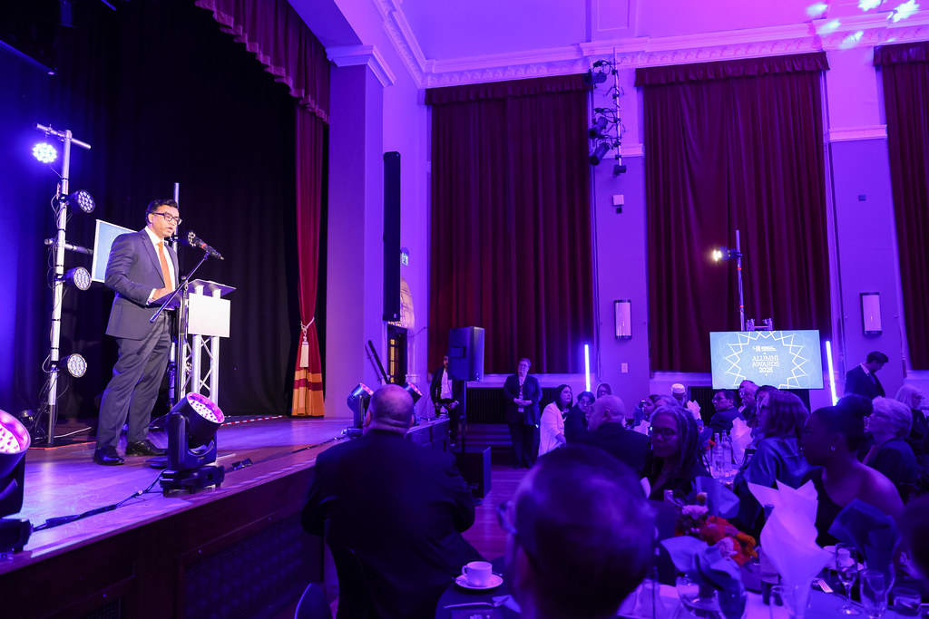 Professor Pillai on stage during his opening speech at the Alumni Awards 2025