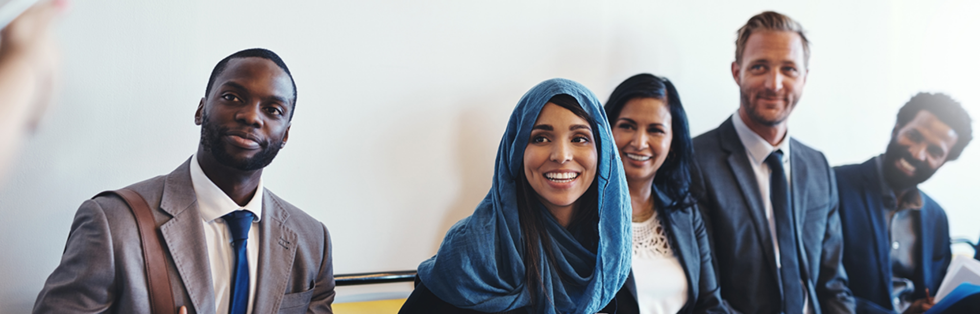 Two students outside a building in conversation with each other.