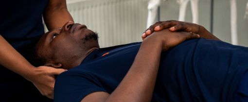 Female student massaging male student's head