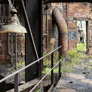 Brownfield site, rusted building, bridge and light.