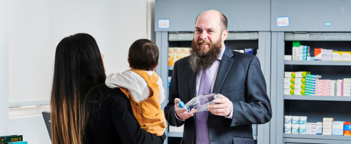 Man holding an inhaler in front of a dispensary