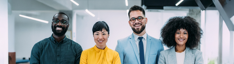 International Agents dressed smartly looking at the camera in an office
