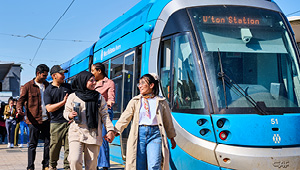 Students walking from tram station along platform